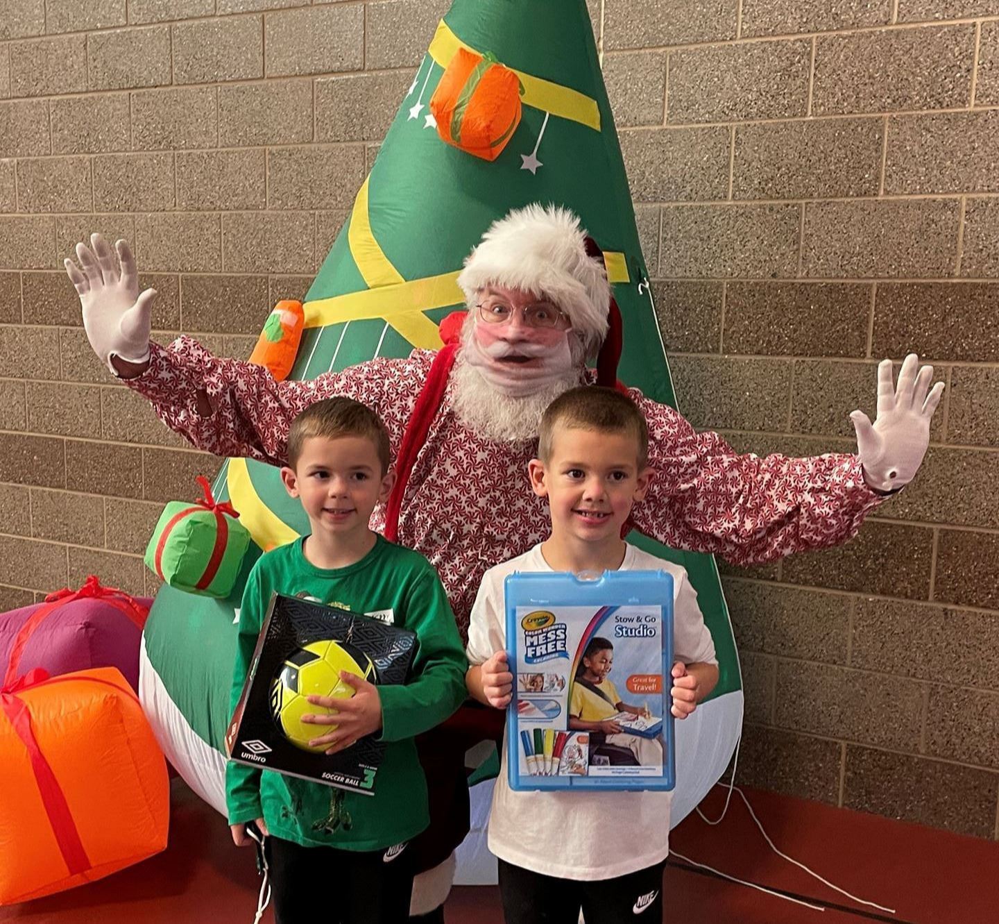 Photo of Santa with 2 boys and their gifts