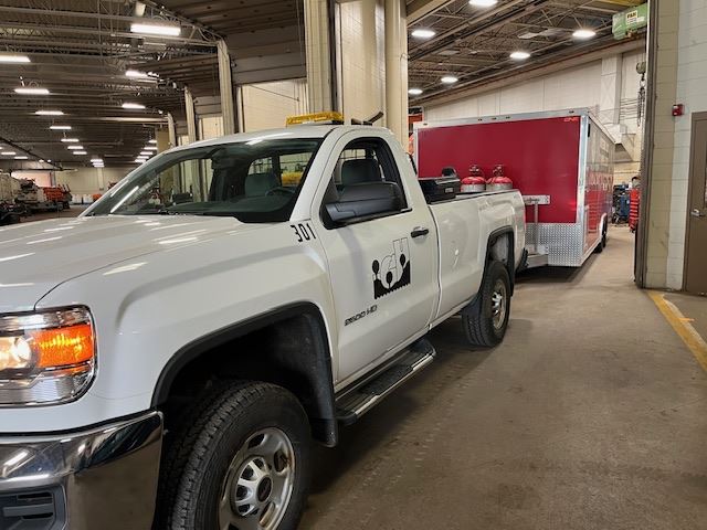 Trailer Being Serviced Attached to a White Truck
