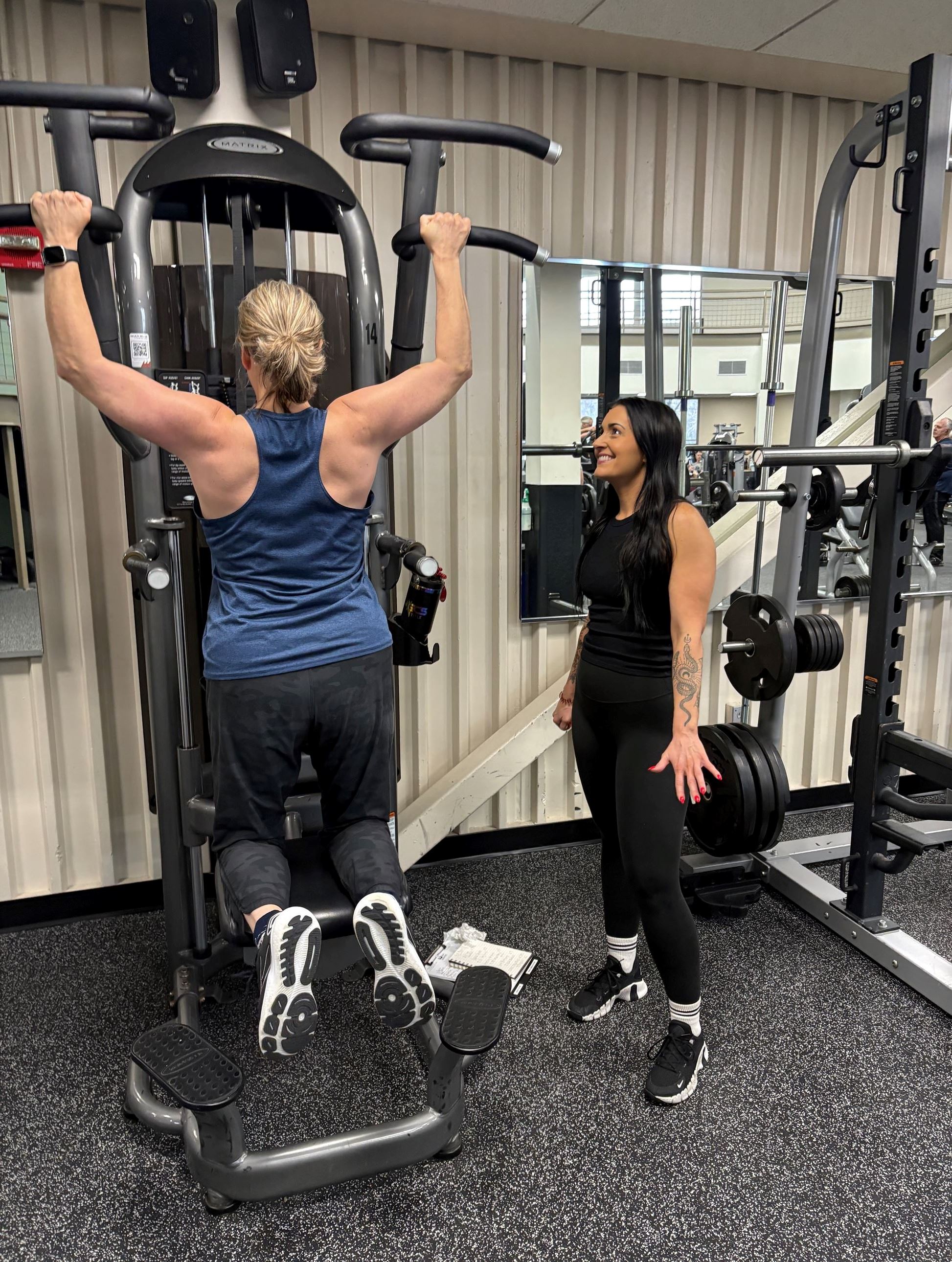 Personal trainer working with a client in the fitness center
