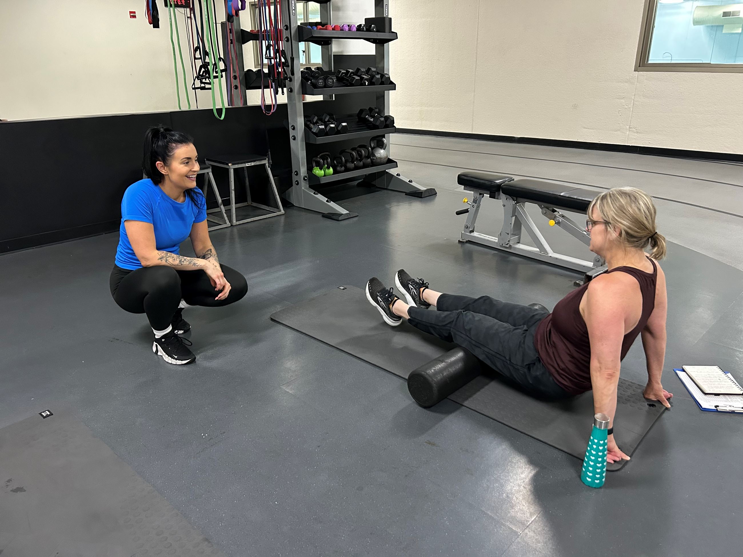 Personal trainer working with a client in the fitness center