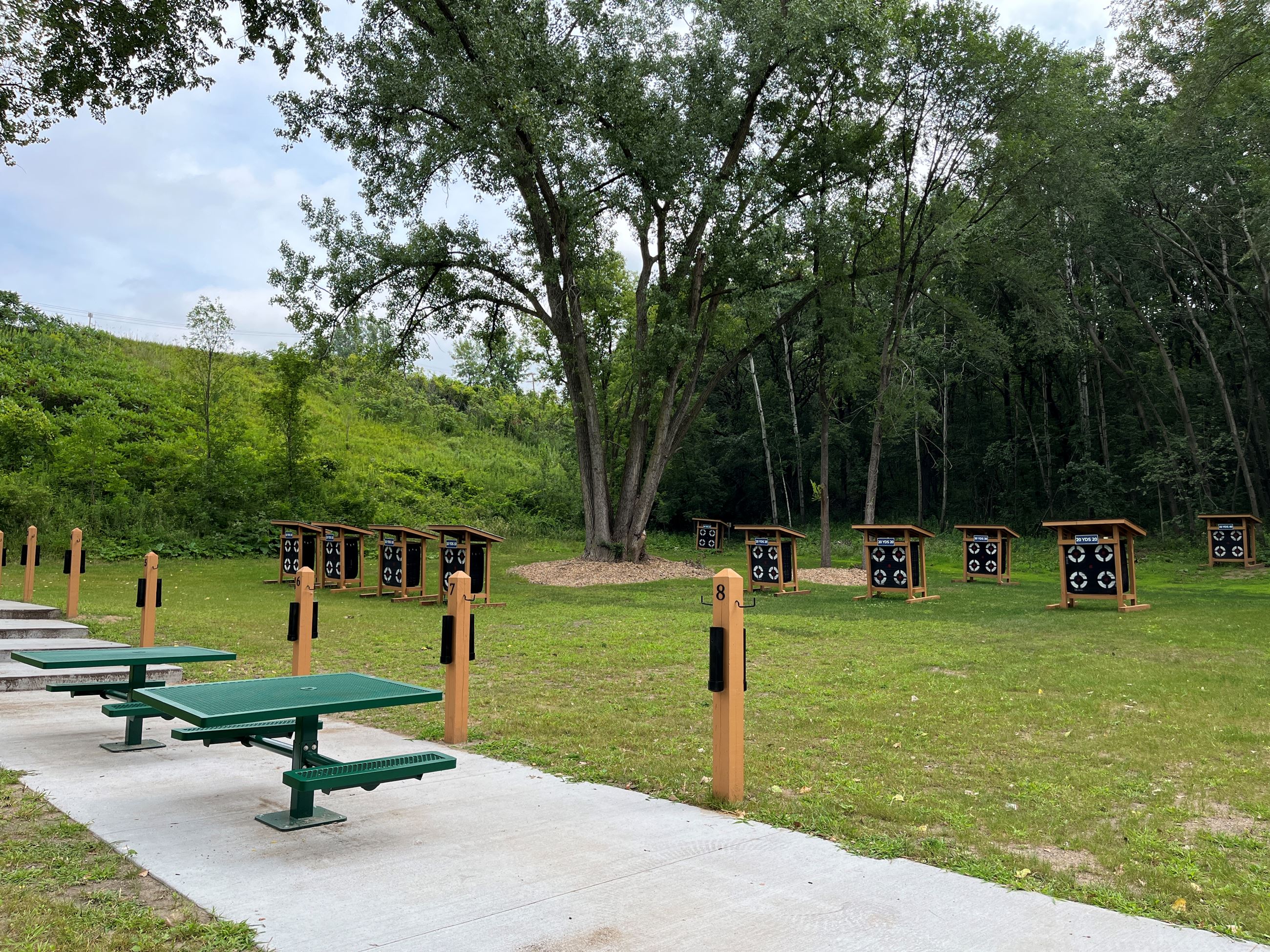 Ground level targets next to picnic benches at the South Valley Park archery range